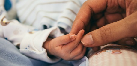 Baby hand holding_457x220