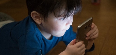 Boy with phone_457x220