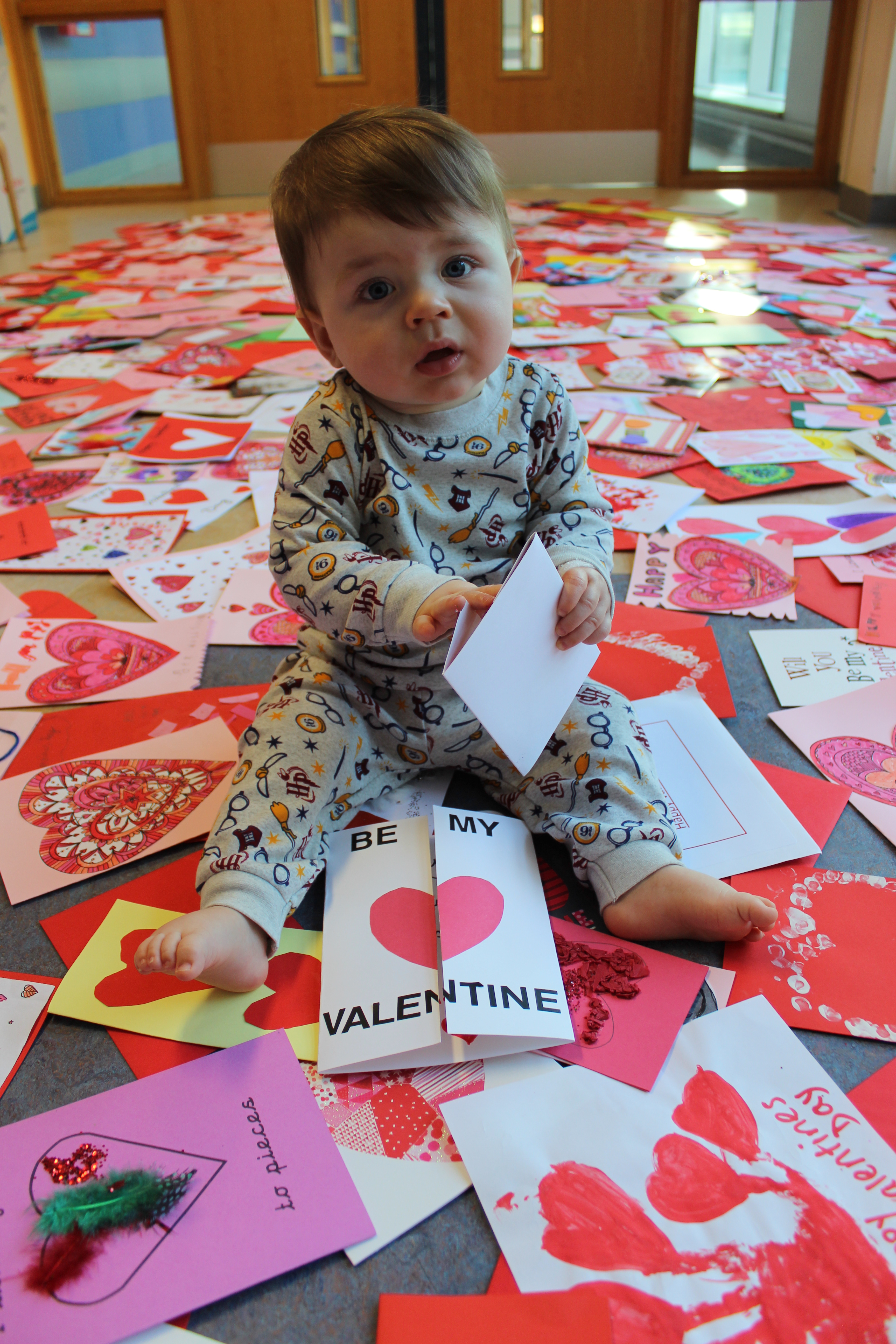 Young heart patient surrounded by Valentine's cards on Ocean Ward
