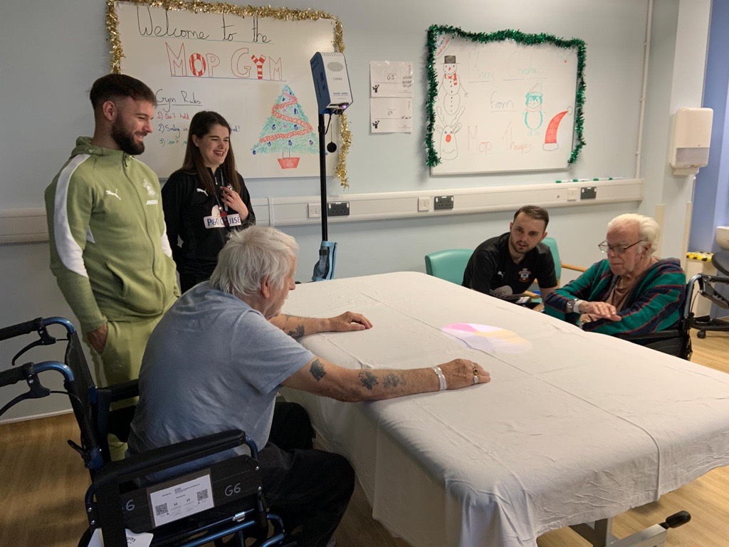 Adam Armstrong with patients and Jake Batchelor