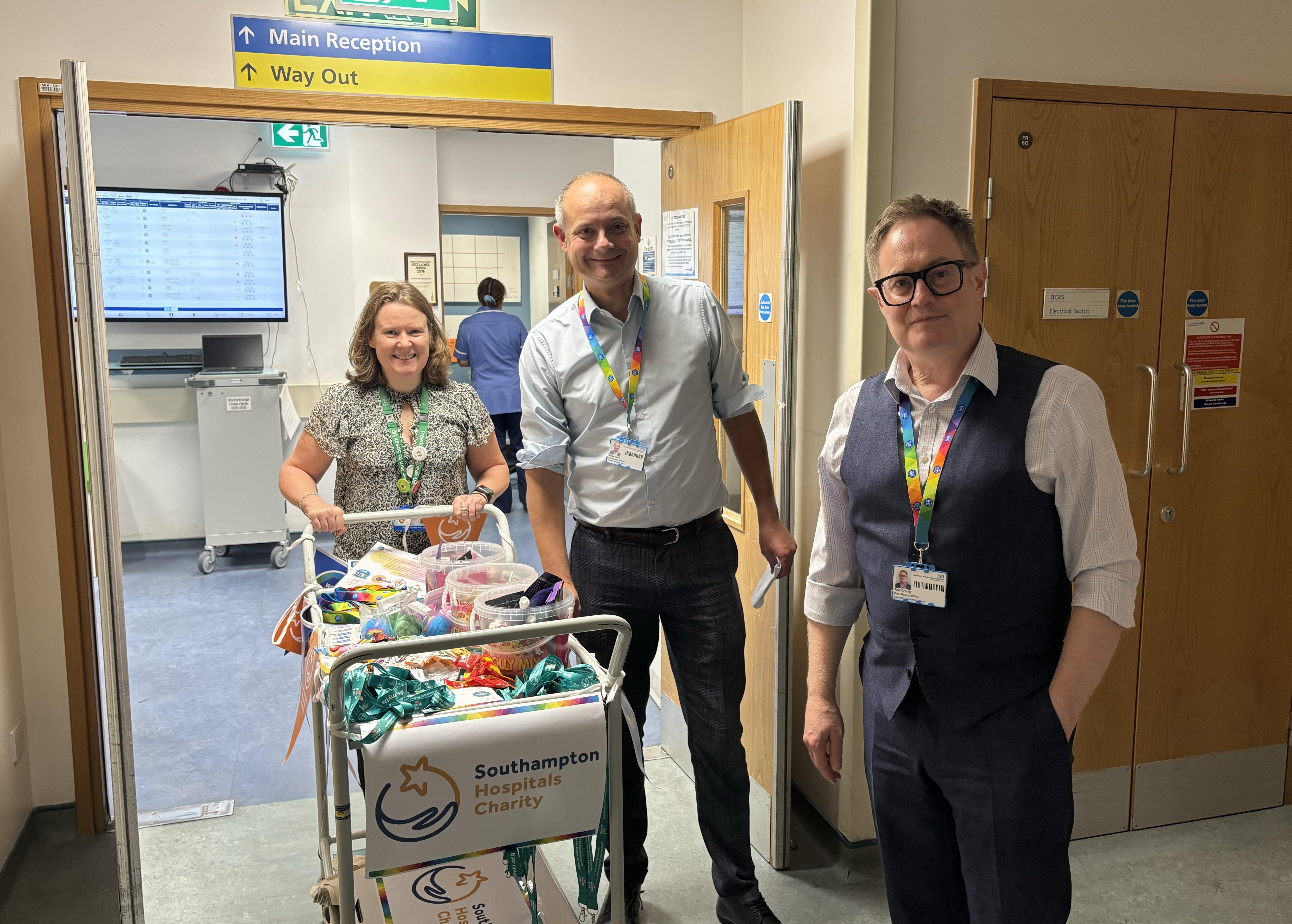Three executives with a trolley preparing to visit wards