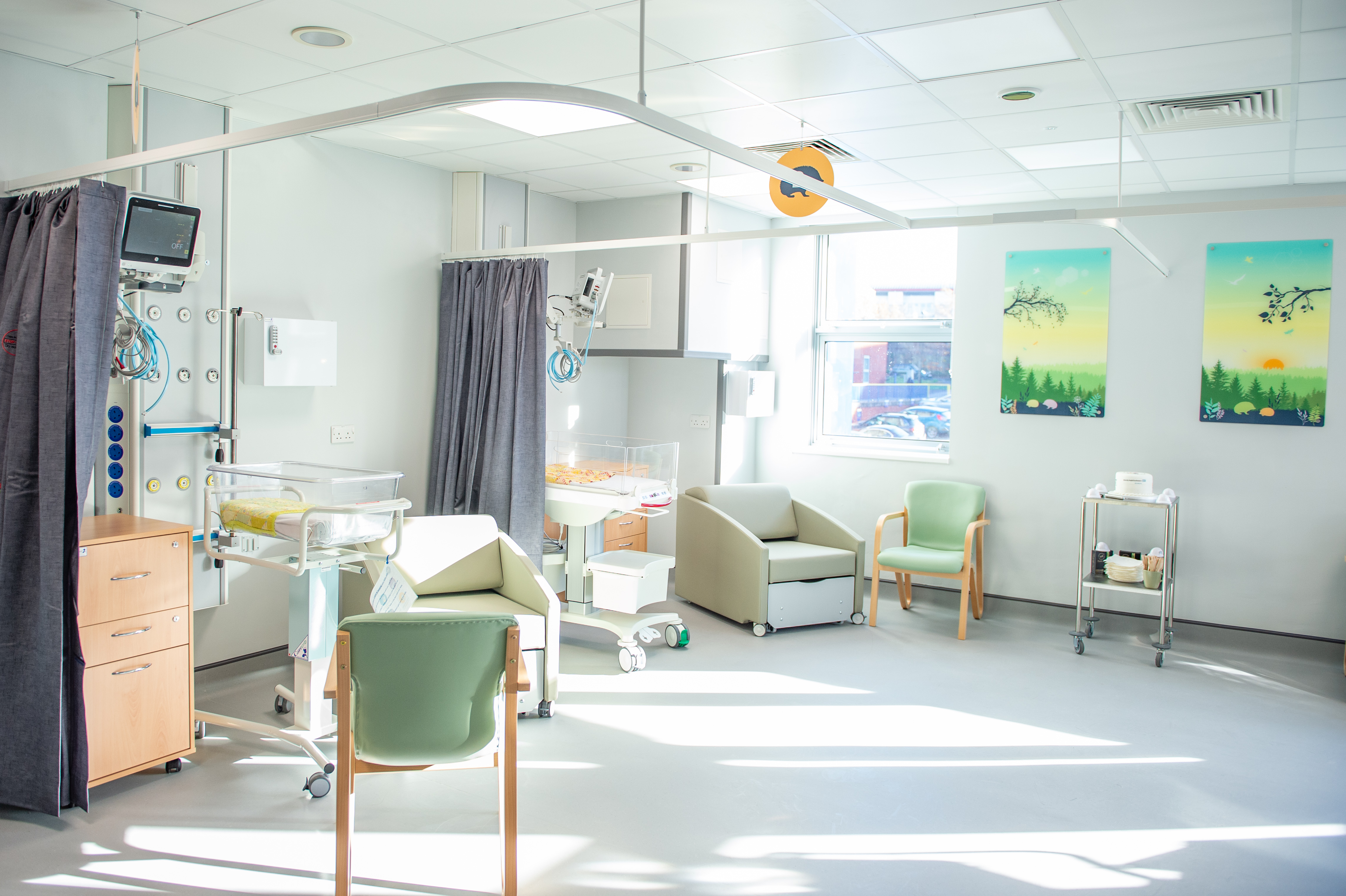 Several chairs and cots in ward spaces in Hedgehogs room