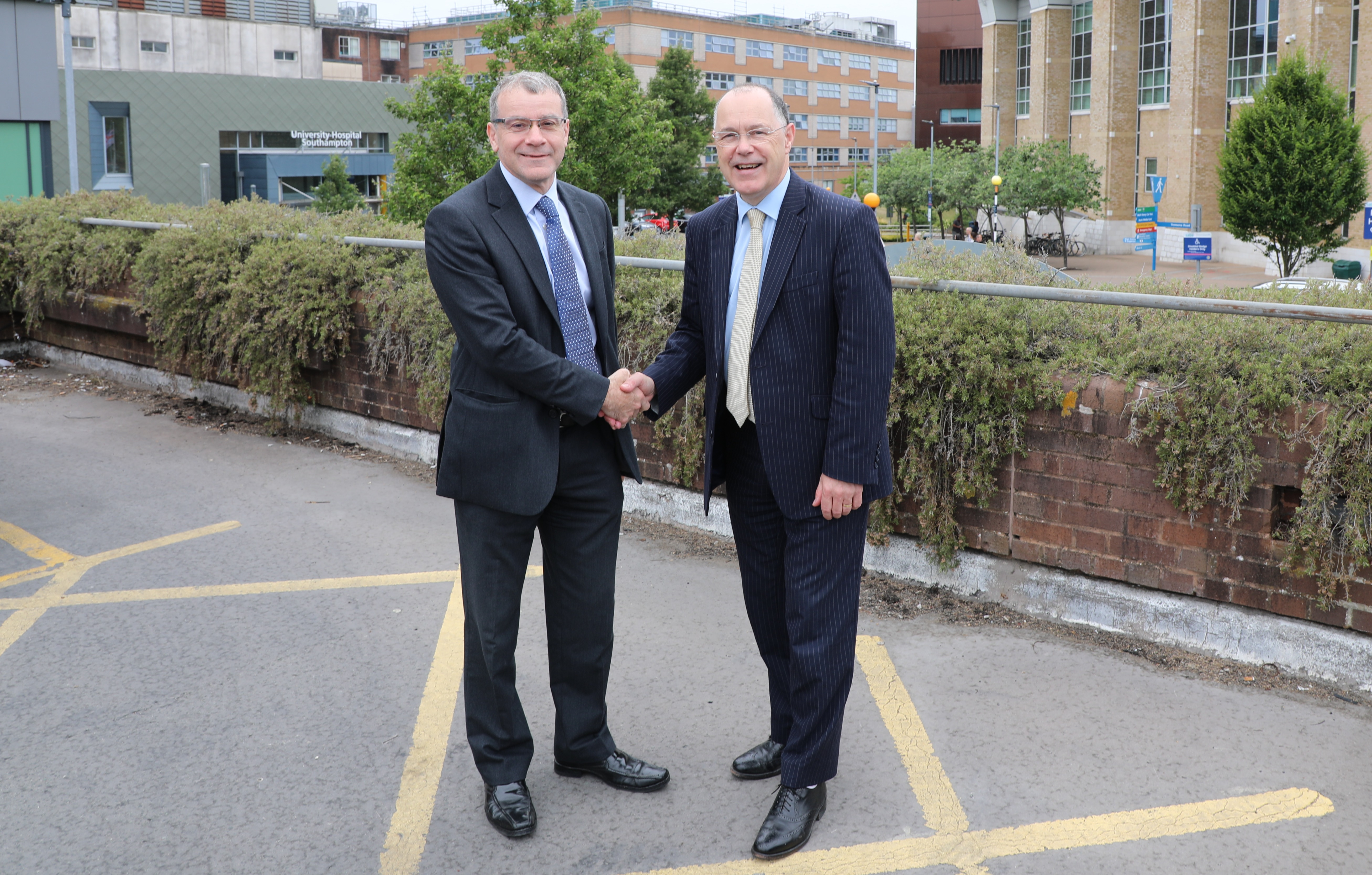 David French shaking hands with Professor Mark E. Smith