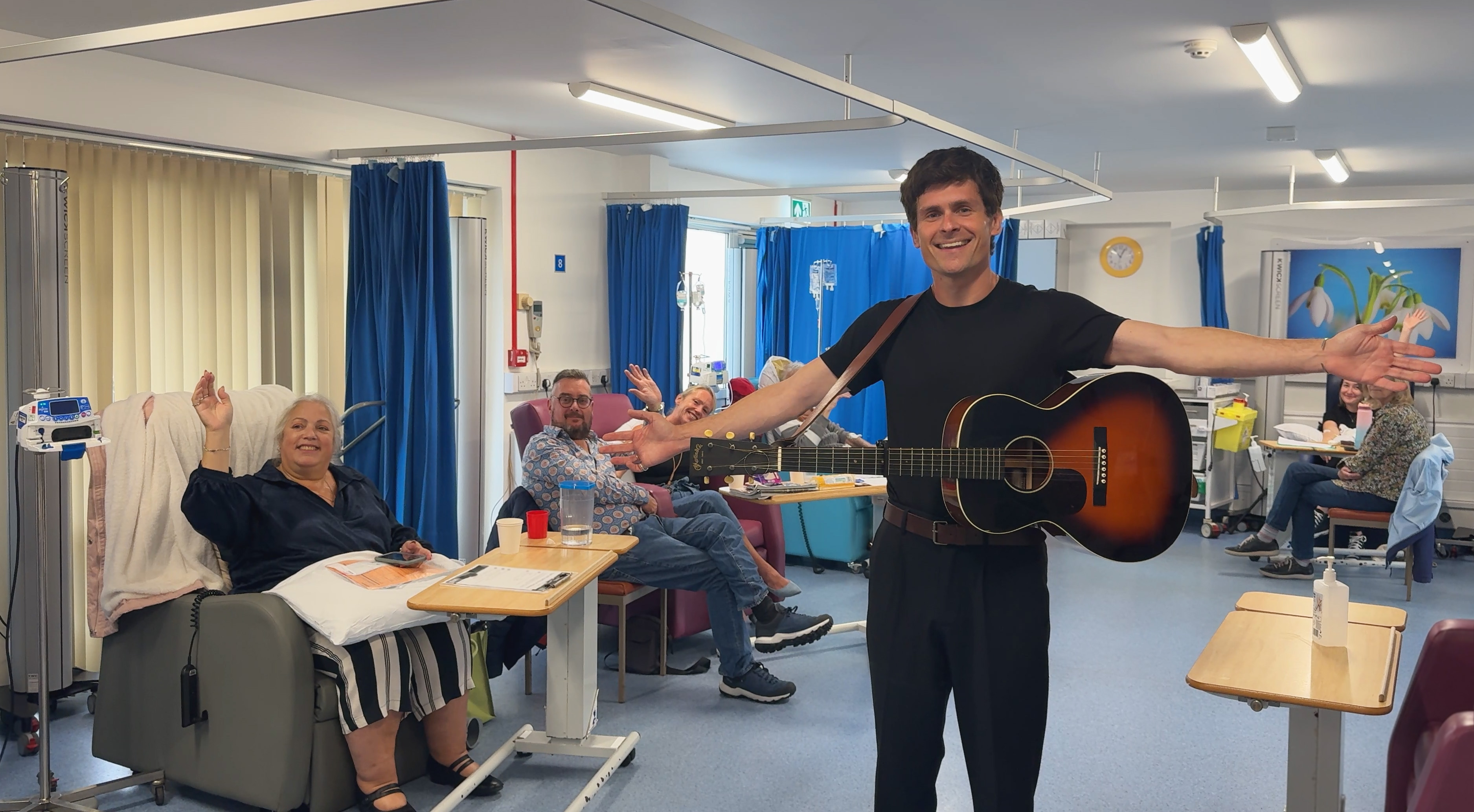 Tom standing with IBD patients on a ward