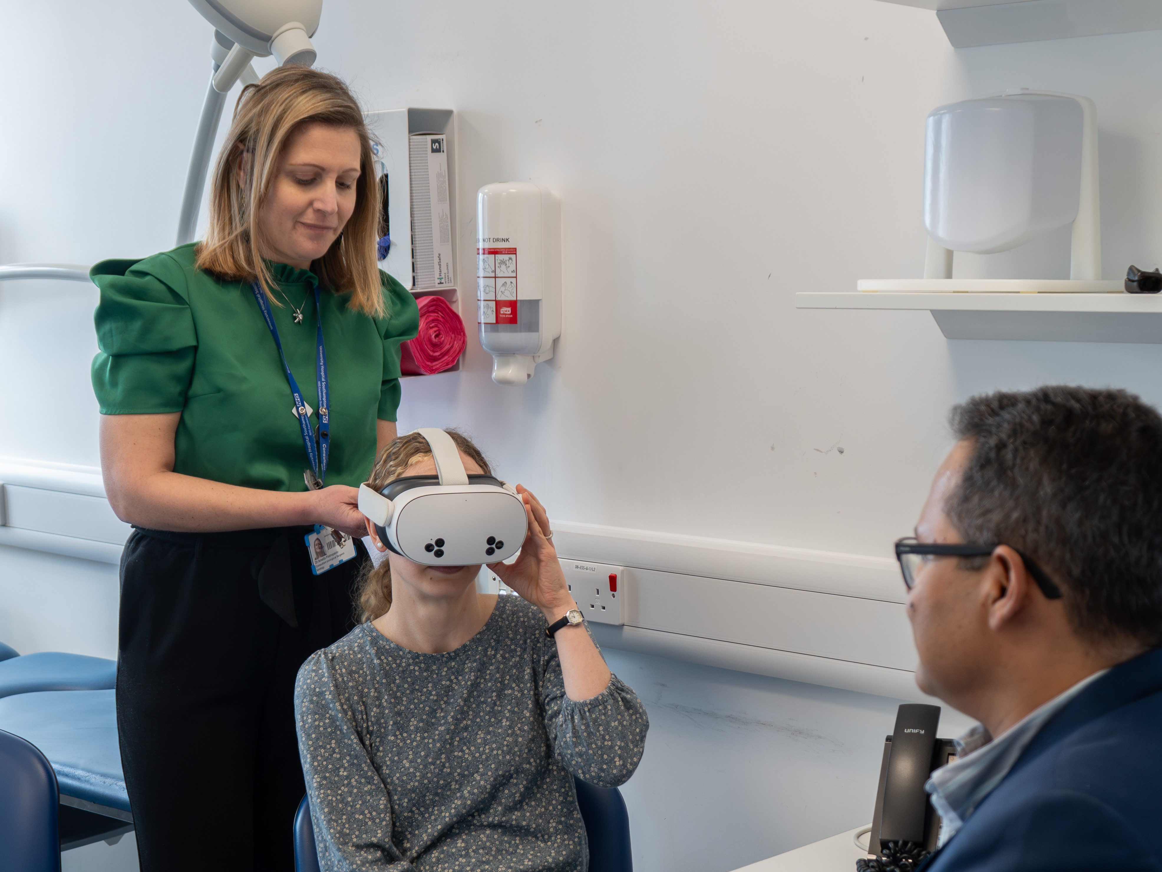 Consultant fixing VR headset on to a person