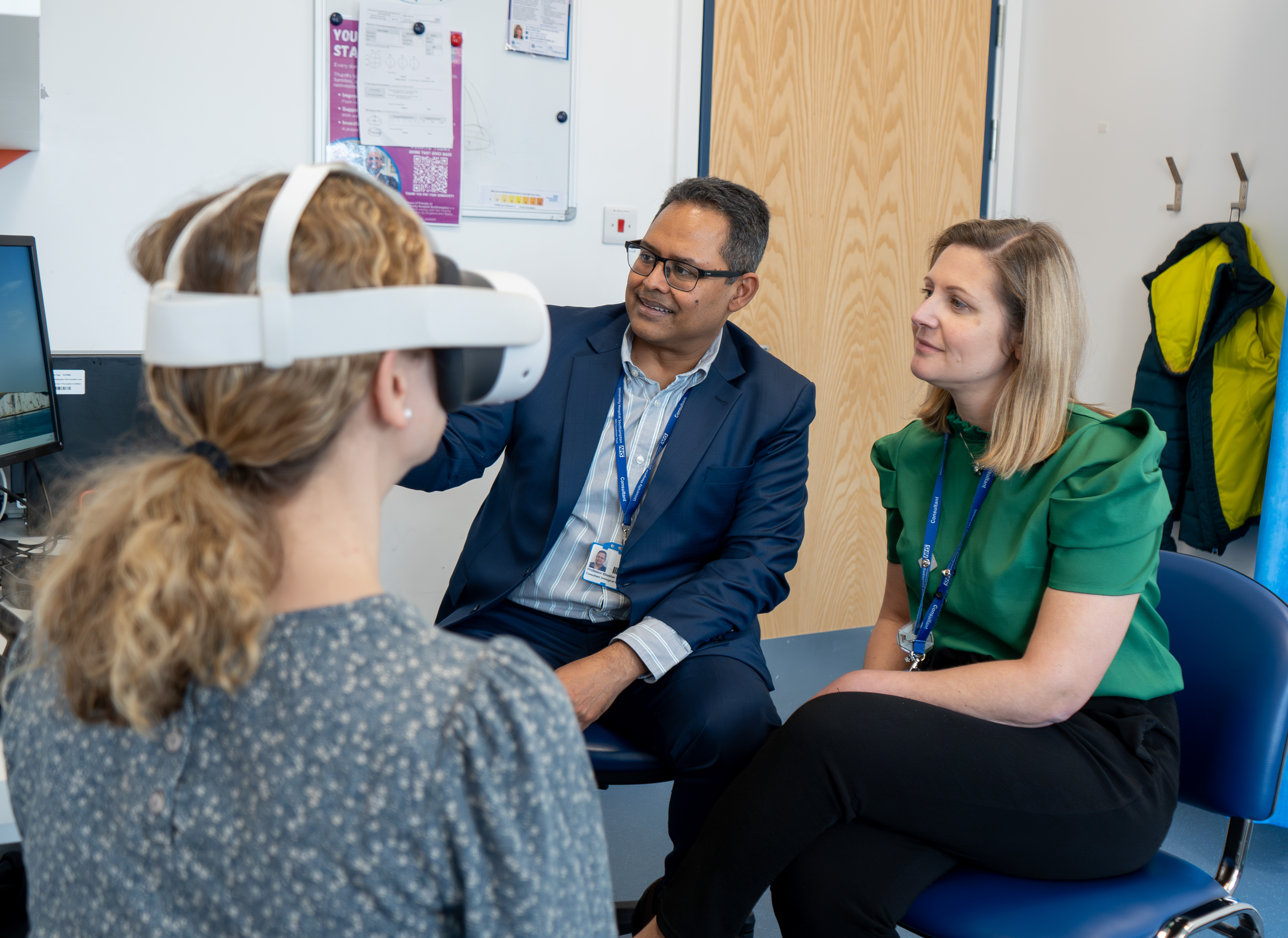 Two consultants in focus with VR headset in foreground