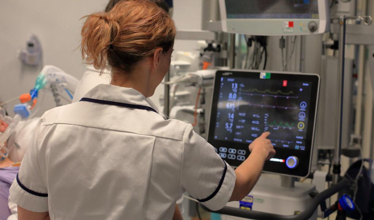 Member of staff pointing at a cardiac monitor