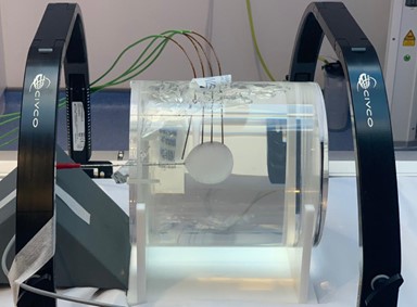 Cyroablation machine, showing a large tube with clear liquid inside and black supports either side.