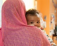 Baby looking over Mum's shoulder