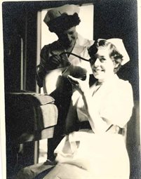 Dorothy and Joan practicing ear nose and throat techniques on each other two of two