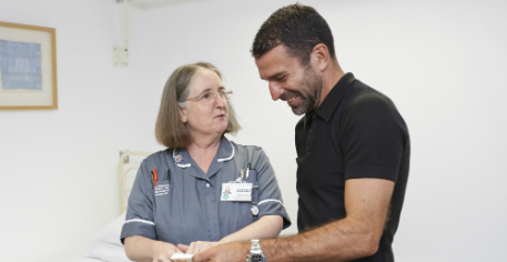 Benali with research nurse - web