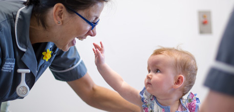 Research nurse with a baby