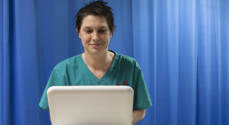 Member of staff with a piece of monitoring equipment