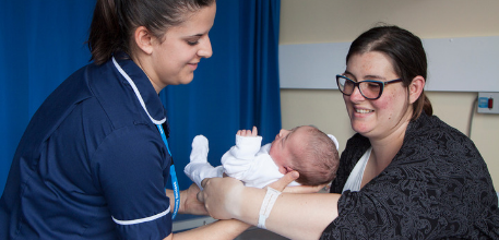 Midwife with mother and baby