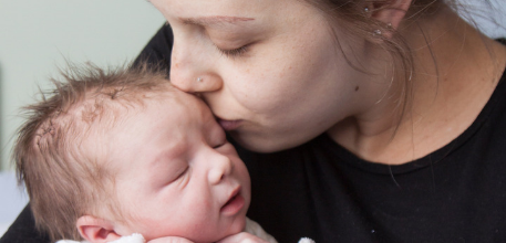 Mother kissing baby